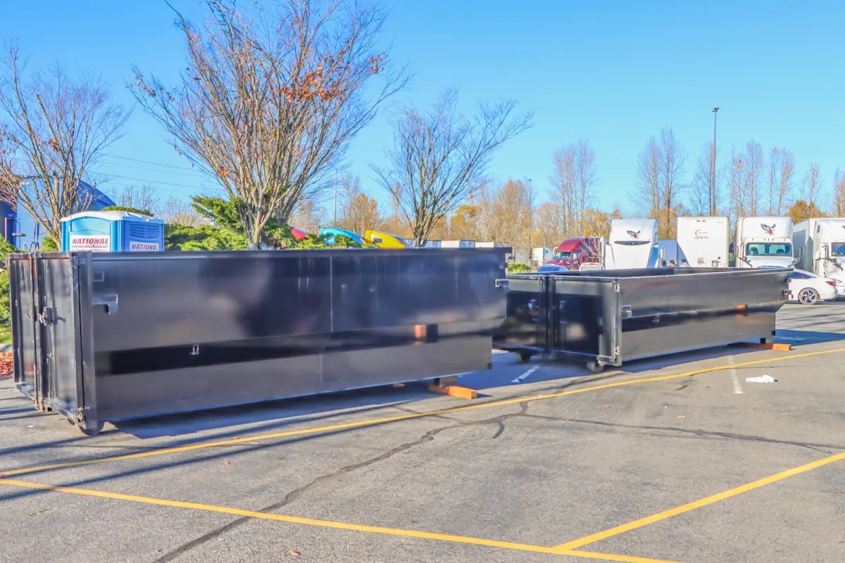 Professional dumpster rental service with roll-off container on residential driveway in Pennsauken